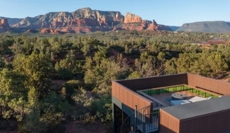 A sky view of an Atrium at Ambiente with a sitting area on the roof and views of the red rocks.