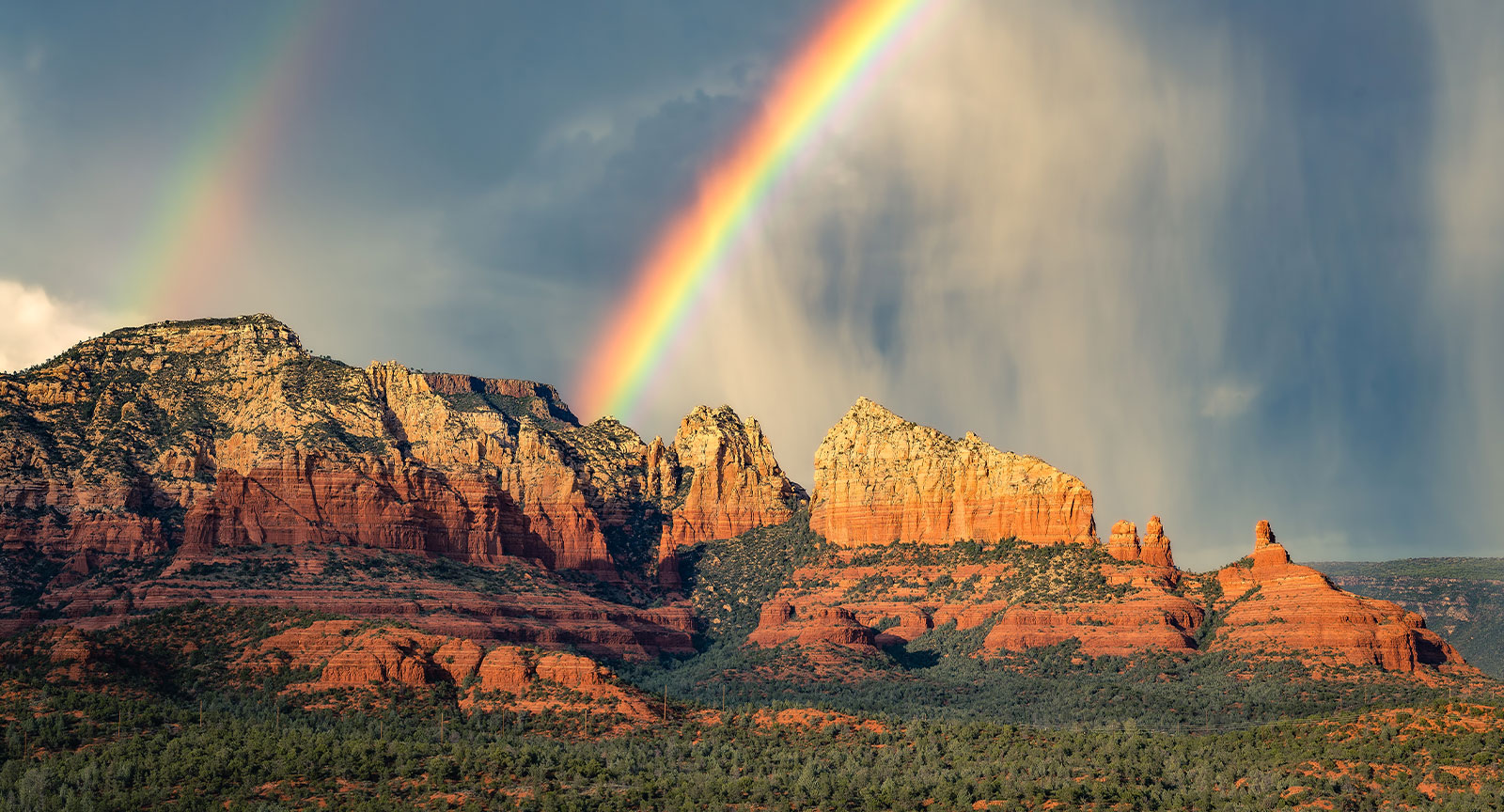 a rainbow over a mountain range