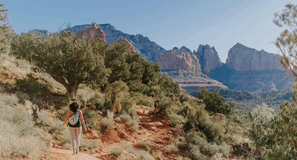 A woman hiking on one of the many hiking trails near Ambiente hotel.
