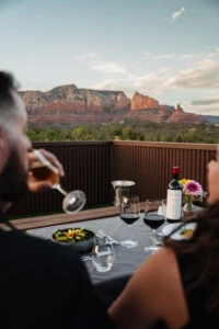 A couple enjoying wine on their private rooftop atrium at Ambiente Sedona