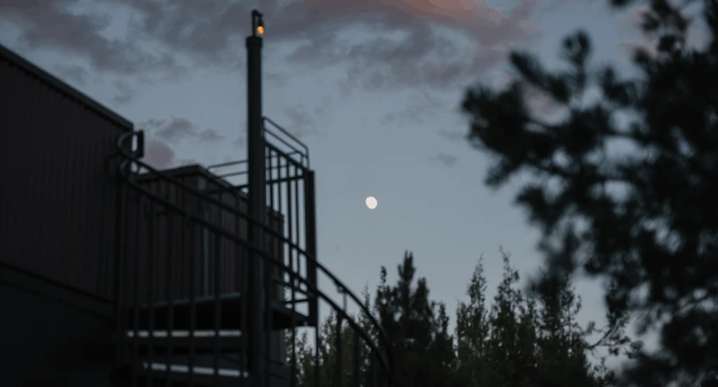 Moon in the sky behind a private atrium at Ambiente Sedona