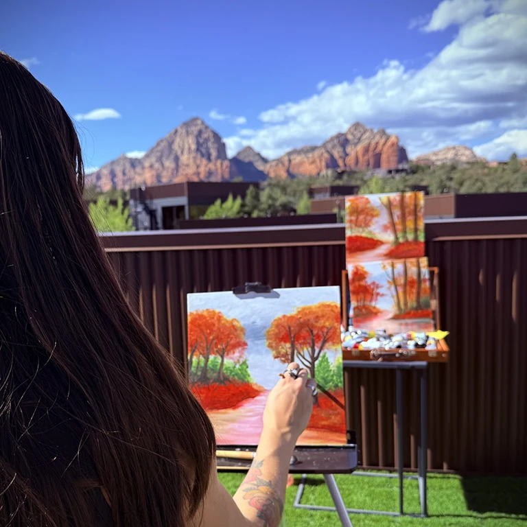A woman painting the red rock landscape at Ambiente during the Beyond the Canvas activity