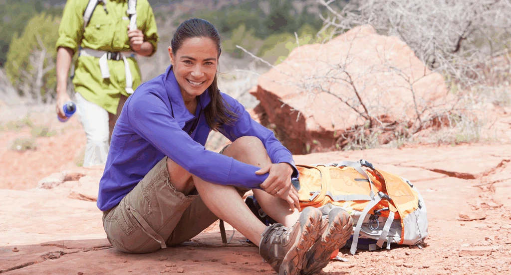 Female hiker on Devil's Bridge Trail Sedona sitting taking a rest