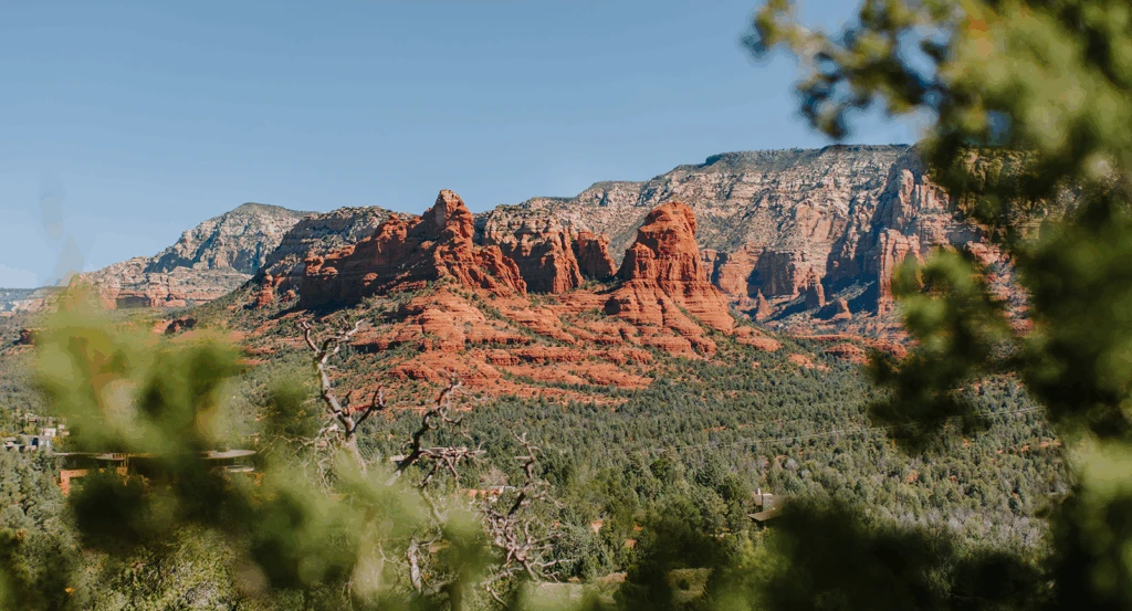 Red rock landscape of Sedona peeking through greenery