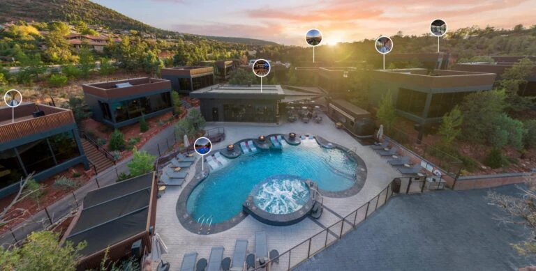 Ambiente hotel aerial view showing pool and modern buildings among Sedona red rocks.
