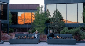 Two guests lounging by a firepit at Ambiente, a landscape hotel in Sedona