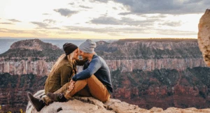 During a Sedona couples getaway, a man and woman embrace atop the rocky landscape.