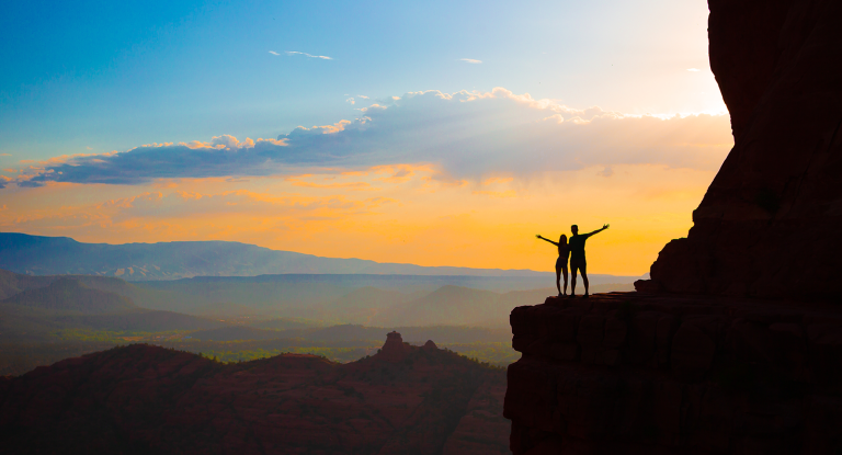 A couple silhouetted by the sunset in Sedona