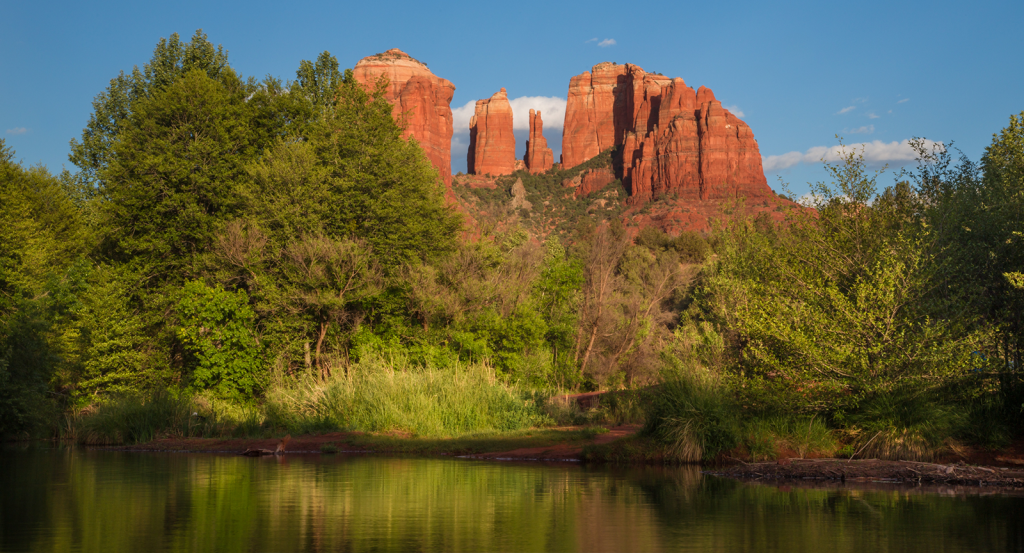 A reflection of Cathedral rock in a calm swimming hole in Sedona