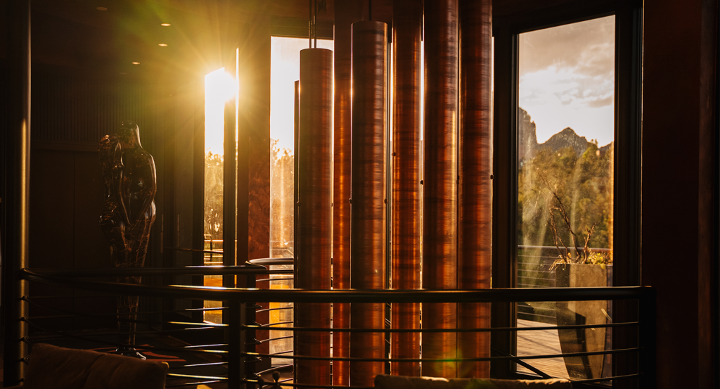 Sun peaking through the windchime installation leading to Velvet, a spa hotel in Sedona