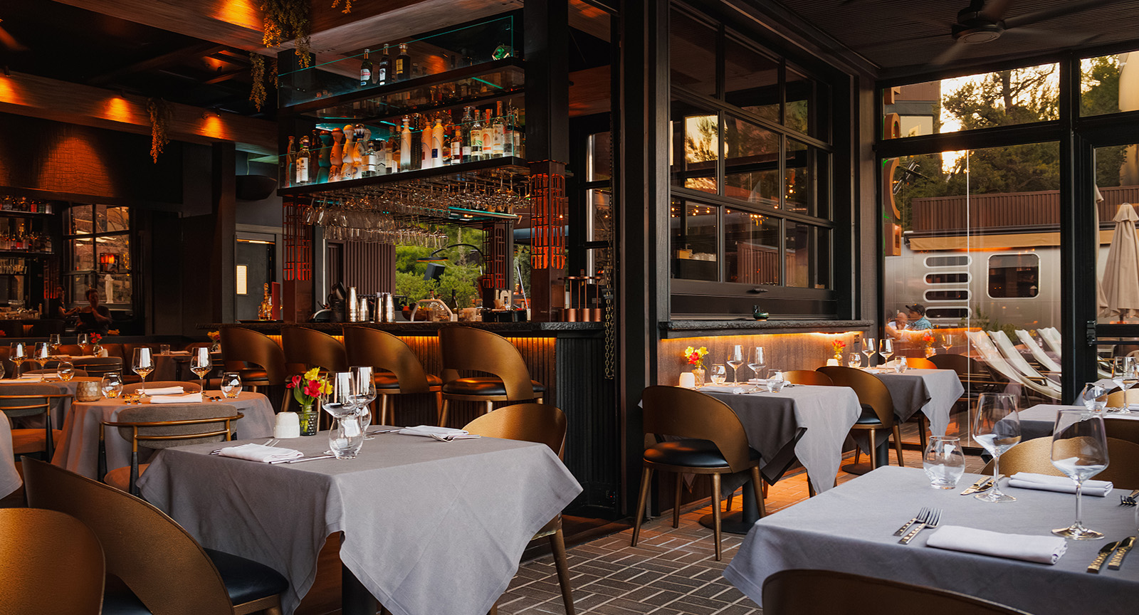 a restaurant dining area with tables set for dinner